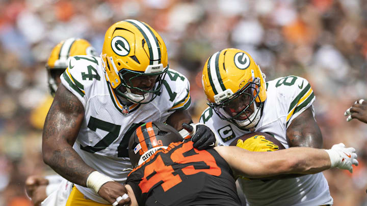 Sep 21, 2025; Cleveland, Ohio, USA; Green Bay Packers running back Josh Jacobs (8) runs the ball as guard Elgton Jenkins (74) blocks Cleveland Browns linebacker Carson Schwesinger (49) during the third quarter at Huntington Bank Field. Mandatory Credit: Scott Galvin-Imagn Images