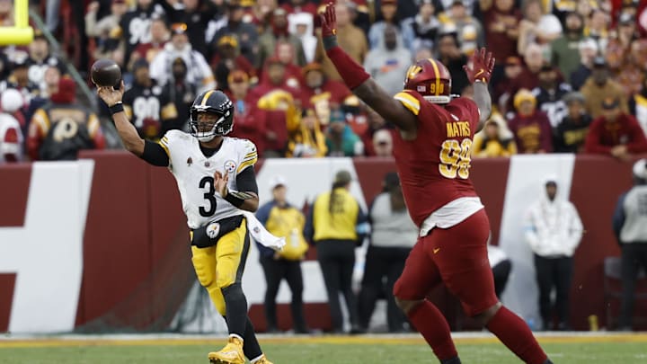 Nov 10, 2024; Landover, Maryland, USA; Pittsburgh Steelers quarterback Russell Wilson (3) passes the ball as Washington Commanders defensive end Clelin Ferrell (99) chases during the second half at Northwest Stadium. Mandatory Credit: Geoff Burke-Imagn Images