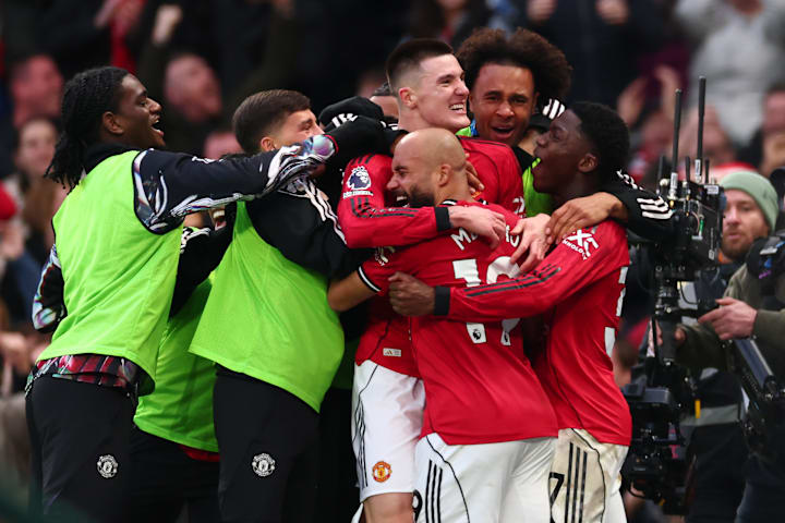Manchester United players celebrating together.