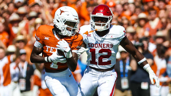Oct 7, 2023; Dallas, Texas, USA;  Texas Longhorns wide receiver Xavier Worthy (1) runs with the ball as Oklahoma Sooners defensive back Key Lawrence (12) chases during the first half at the Cotton Bowl. Mandatory Credit: Kevin Jairaj-Imagn Images