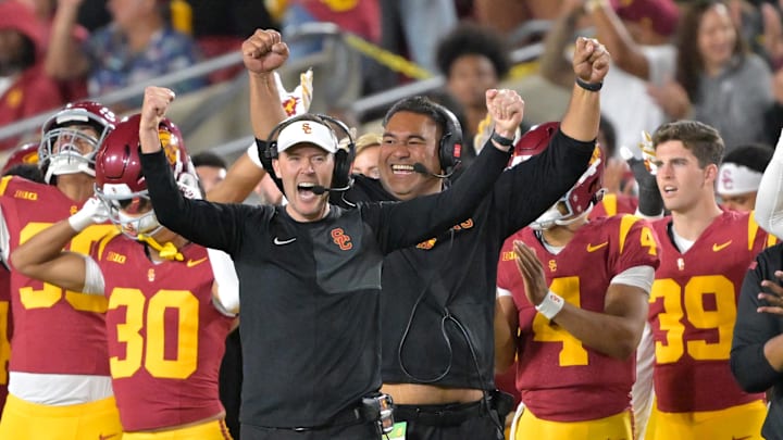 Oct 11, 2025; Los Angeles, California, USA; USC Trojans head coach Lincoln Riley (wearing white visor) celebrates along with defensive end coach Shaun Nua after kicker Ryon Sayeri (48) hit a 54-yard field goal in the second half against the Michigan Wolverines at United Airlines Field at the Los Angeles Memorial Coliseum. Oct 11, 2025; Los Angeles, California, USA; USC Trojans head coach Lincoln Riley (wearing white visor) celebrates along with defensive end coach Shaun Nua after kicker Ryon Sayeri (48) hit a 54-yard field goal in the second half against the Michigan Wolverines at United Airlines Field at the Los Angeles Memorial Coliseum.