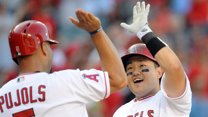 Angels left fielder Ji-Man Choi (51) is congratulated by designated hitter Albert Pujols (5) after he hits a three run home run in the third inning against Oakland Athletics at Angel Stadium of Anaheim. 