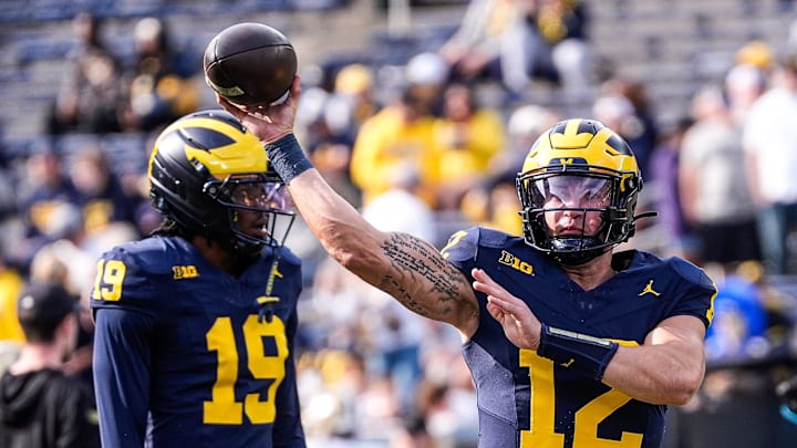 Michigan quarterback Jake Garcia (12) warms up ahead of the Washington game at Michigan Stadium in Ann Arbor on Saturday, Oct. 18, 2025.