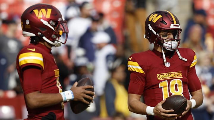 Nov 24, 2024; Landover, Maryland, USA; Washington Commanders quarterback Jayden Daniels (5) and Commanders quarterback Marcus Mariota (18) stand on the field during warmup prior to the game against the Dallas Cowboys at Northwest Stadium. Mandatory Credit: Geoff Burke-Imagn Images
