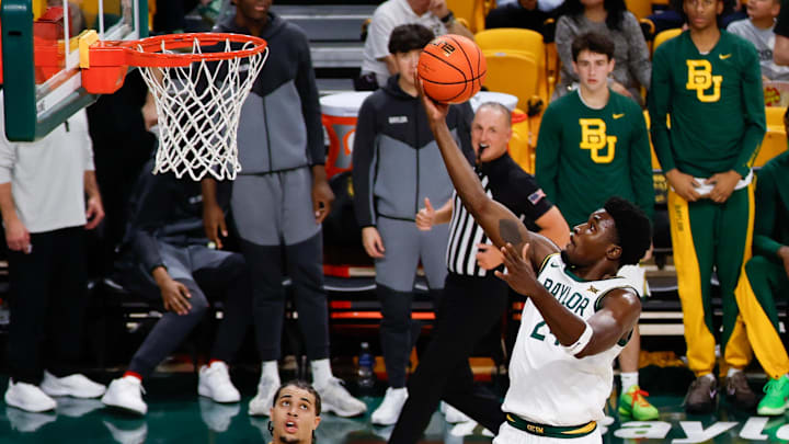 Dec 10, 2025; Waco, Texas, USA; Baylor Bears guard Tounde Yessoufou (24) scores a layup against Norfolk State Spartans forward Devon Ellis (11) during the second half at Paul and Alejandra Foster Pavilion. Mandatory Credit: Chris Jones-Imagn Images