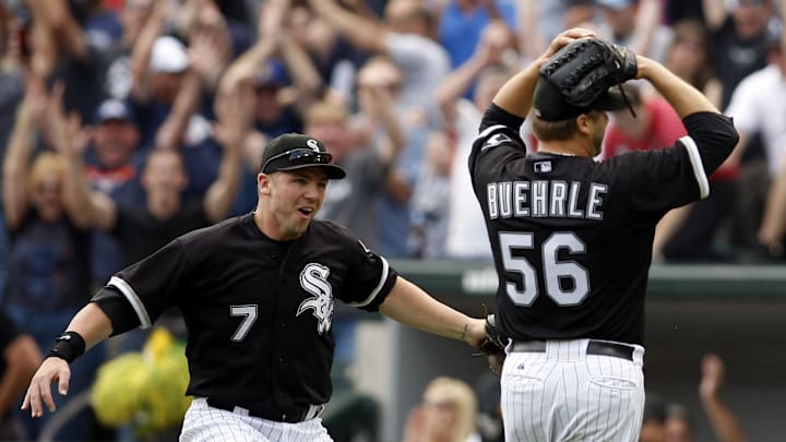 Chicago White Sox starting pitcher Mark Buehrle (56) celebrates with teammate Josh Fields (7) after throwing a perfect game against the Tampa Bay Rays.