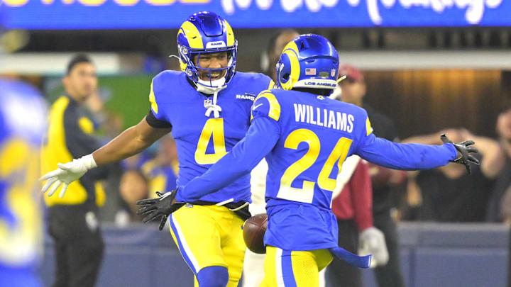 Dec 28, 2024; Inglewood, California, USA; Los Angeles Rams cornerback Ahkello Witherspoon (4) celebrates with cornerback Darious Williams (24) after an interception in the end zone against the Arizona Cardinals in the fourth quarter at SoFi Stadium. Mandatory Credit: Jayne Kamin-Oncea-Imagn Images