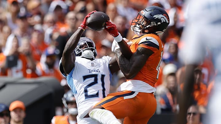 Sep 7, 2025; Denver, Colorado, USA; Tennessee Titans cornerback Roger McCreary (21) intercepts a ball from Denver Broncos wide receiver Courtland Sutton (14) in the first half at Empower Field at Mile High. Mandatory Credit: Isaiah J. Downing-Imagn Images Sep 7, 2025; Denver, Colorado, USA; Tennessee Titans cornerback Roger McCreary (21) intercepts a ball from Denver Broncos wide receiver Courtland Sutton (14) in the first half at Empower Field at Mile High. Mandatory Credit: Isaiah J. Downing-Imagn Images