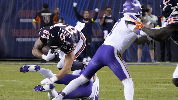Colston Loveland makes a short catch and is hauled down against the Vikings in the season opener.