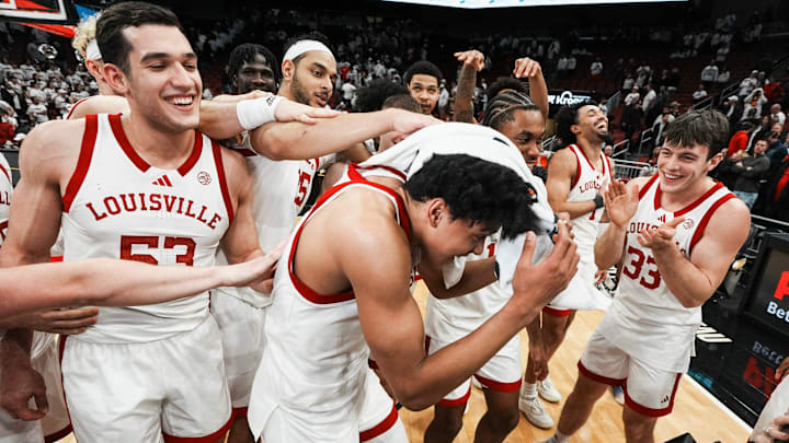 After scoring 45 points to tie Wes Unseld's game record, Louisville Cardinals guard Mikel Brown Jr. (0) gets congratulated by his teammates after an interview as the Cards roll past NC State 118-77 at the KFC Yum! Center in downtown Louisville February 9, 2026.