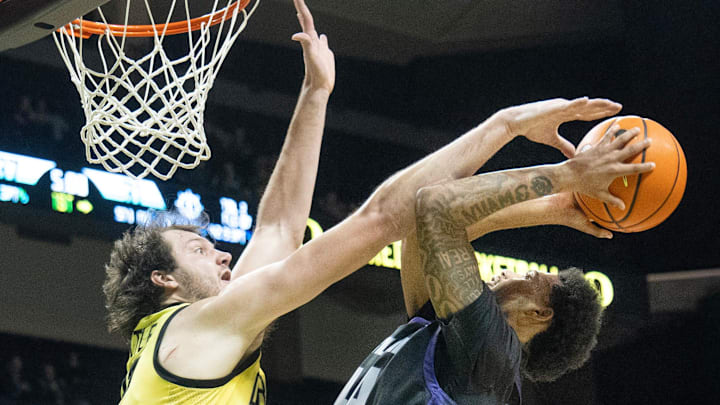 Oregon’s Nate Bittle tries for a block on Portland’s Timo George during the first half at Matthew Knight Arena in Eugene Dec. 17, 2025.