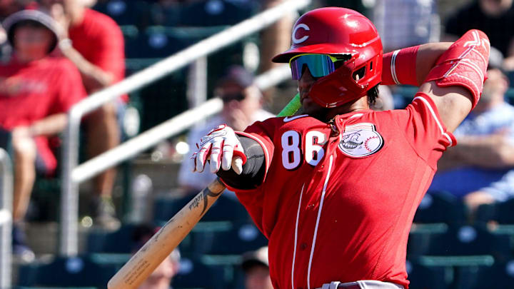 Cincinnati Reds outfielder Allan Cerda (86) corrals a wild swing during a spring training baseball game.