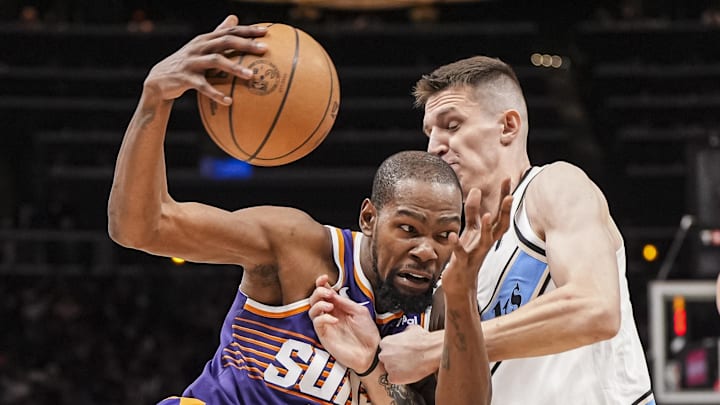 Jan 14, 2025; Atlanta, Georgia, USA; Phoenix Suns forward Kevin Durant (35) is defended by Atlanta Hawks guard Vit Krejci (27) during the second half at State Farm Arena. Mandatory Credit: Dale Zanine-Imagn Images