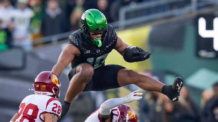 Oregon tight end Kenyon Sadiq hurdles over USC cornerback DeCarlos Nicholson as the Oregon Ducks host the USC Trojans on Nov. 22, 2025, at Autzen Stadium in Eugene, Oregon.