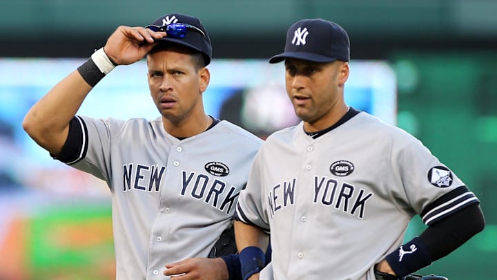 Oct 16, 2010; Arlington, TX, USA; New York Yankees third baseman Alex Rodriguez (left) and shortstop Derek Jeter wait during a pitching change during the seventh inning of game two of the 2010 ALCS against the Texas Rangers at Rangers Ballpark. Mandatory Credit: Matthew Emmons-Imagn Images