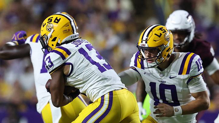 Sep 26, 2026; Baton Rouge, Louisiana, USA;  LSU Tigers quarterback Sam Leavitt (10) hands off the ball to running back Dilin Jones (13) during the second quarter against the Texas A&M Aggies at Tiger Stadium.  Mandatory Credit: Stephen Lew-Imagn Images