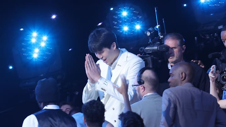 Jun 25, 2025; Brooklyn, NY, USA;  Yang Hansen walks to the stage after being selected as the 16th pick by the Memphis Grizzlies in the first round of the 2025 NBA Draft at Barclays Center. Mandatory Credit: Brad Penner-Imagn Images