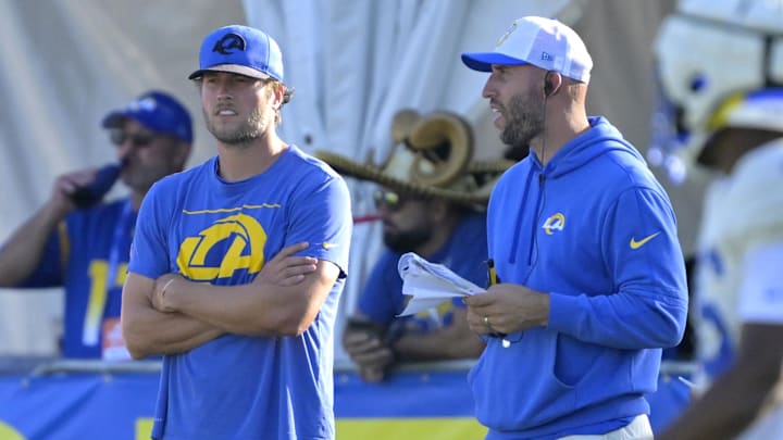 Jul 29, 2024; Los Angeles, CA, USA; Los Angeles Rams quarterback Matthew Stafford (9) talks with quarterback coach Dave Ragone during training camp at Loyola Marymount University. Mandatory Credit: Jayne Kamin-Oncea-Imagn Images Jul 29, 2024; Los Angeles, CA, USA; Los Angeles Rams quarterback Matthew Stafford (9) talks with quarterback coach Dave Ragone during training camp at Loyola Marymount University. Mandatory Credit: Jayne Kamin-Oncea-Imagn Images
