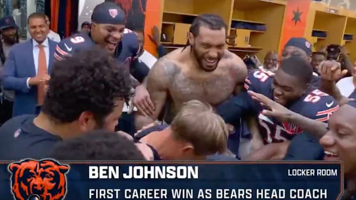 Bears players mob Ben Johnson after his first win.