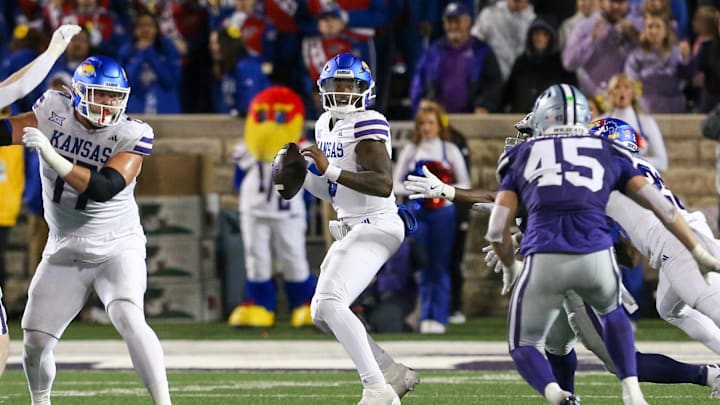 Oct 26, 2024; Manhattan, Kansas, USA; Kansas Jayhawks quarterback Jalon Daniels (6) drops back to pass during the fourth quarter against the Kansas State Wildcats at Bill Snyder Family Football Stadium. Mandatory Credit: Scott Sewell-Imagn Images Oct 26, 2024; Manhattan, Kansas, USA; Kansas Jayhawks quarterback Jalon Daniels (6) drops back to pass during the fourth quarter against the Kansas State Wildcats at Bill Snyder Family Football Stadium. Mandatory Credit: Scott Sewell-Imagn Images