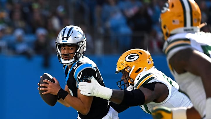 Dec 24, 2023; Charlotte, North Carolina, USA; Carolina Panthers quarterback Bryce Young (9) looks to pass as Green Bay Packers defensive tackle Kenny Clark (97) pressures in the first quarter at Bank of America Stadium. Mandatory Credit: Bob Donnan-Imagn Images Dec 24, 2023; Charlotte, North Carolina, USA; Carolina Panthers quarterback Bryce Young (9) looks to pass as Green Bay Packers defensive tackle Kenny Clark (97) pressures in the first quarter at Bank of America Stadium. Mandatory Credit: Bob Donnan-Imagn Images