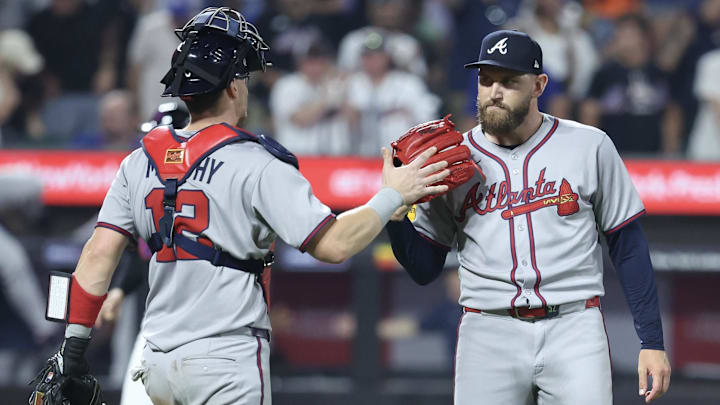 Jun 23, 2025; New York City, New York, USA;  Atlanta Braves catcher Sean Murphy (12) and relief pitcher Dylan Lee (52) congratulate each other after defeating the New York Mets 3-2 at Citi Field. Mandatory Credit: Wendell Cruz-Imagn Images