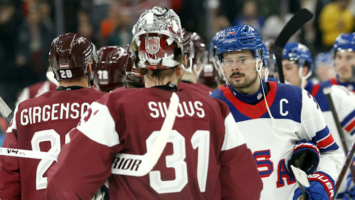 Feb 12, 2026; Milan, Italy; Auston Matthews of United States shakes hands with Arturs Silovs of Latvia after the match  in men's ice hockey group C play during the Milano Cortina 2026 Olympic Winter Games at Milano Santagiulia Ice Hockey Arena. Mandatory Credit: Geoff Burke-Imagn Images