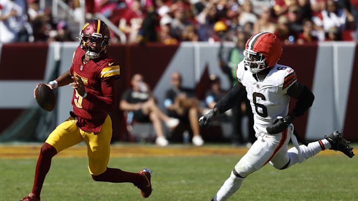 Oct 6, 2024; Landover, Maryland, USA; Washington Commanders quarterback Jayden Daniels (5) runs with the ball as Cleveland Browns linebacker Jeremiah Owusu-Koramoah (6) chases during the second quarter at NorthWest Stadium. Mandatory Credit: Geoff Burke-Imagn Images