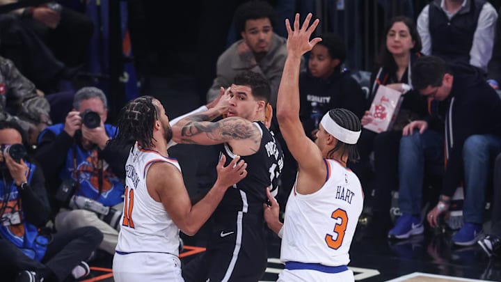 Jan 21, 2026; New York, New York, USA;  Brooklyn Nets forward Michael Porter Jr. (17) is double teammed by New York Knicks guards Jalen Brunson (11) and Josh Hart (3) in the first quarter at Madison Square Garden. Mandatory Credit: Wendell Cruz-Imagn Images