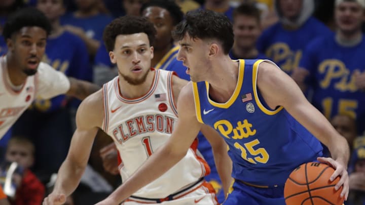 Jan 18, 2025; Pittsburgh, Pennsylvania, USA; Pittsburgh Panthers forward Guillermo Diaz Graham (25) handles the ball against Clemson Tigers guard Chase Hunter (1) during the second half at the Petersen Events Center. Mandatory Credit: Charles LeClaire-Imagn Images