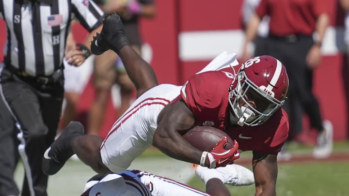 Oct 12, 2024; Tuscaloosa, Alabama, USA;  Alabama Crimson Tide running back Jam Miller (26) is tackled along the sideline by South Carolina Gamecocks defensive back Vicari Swain (4) at Bryant-Denny Stadium. Mandatory Credit: Gary Cosby Jr.-Imagn Images