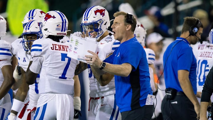 Dec 2, 2023; New Orleans, LA, USA; Southern Methodist Mustangs head coach Rhett Lashlee talks to his players on a time out against the Tulane Green Wave during the second half at Yulman Stadium. Mandatory Credit: Stephen Lew-Imagn Images