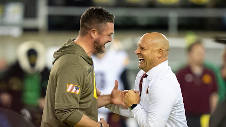Oregon head coach Dan Lanning, left, and Minnesota head coach P. J. Fleck interact before the game as the Oregon Ducks host the Minnesota Golden Gophers on Nov. 14, 2025, at Autzen Stadium in Eugene, Oregon. Oregon head coach Dan Lanning, left, and Minnesota head coach P. J. Fleck interact before the game as the Oregon Ducks host the Minnesota Golden Gophers on Nov. 14, 2025, at Autzen Stadium in Eugene, Oregon.