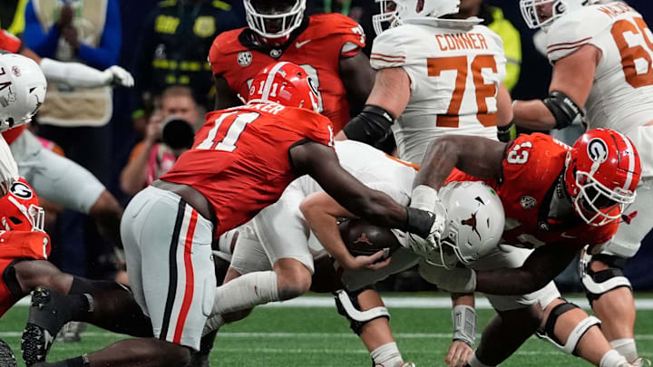 Georgia linebacker Jalon Walker (11) and Georgia defensive lineman Mykel Williams (13) take down Texas quarterback Quinn Ewers (3) during the second half of the SEC championship game against Texas in Atlanta, on Saturday, Dec. 7, 2024. Georgia linebacker Jalon Walker (11) and Georgia defensive lineman Mykel Williams (13) take down Texas quarterback Quinn Ewers (3) during the second half of the SEC championship game against Texas in Atlanta, on Saturday, Dec. 7, 2024.