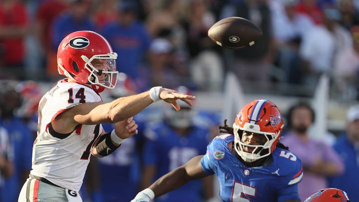Georgia Bulldogs quarterback Gunner Stockton (14) passes under pressure from Florida Gators linebacker Myles Graham (5) during the first half of an NCAA football game at Everbank Stadium in Jacksonville, FL on Saturday, November 1, 2025. [Alan Youngblood/Gainesville Sun]