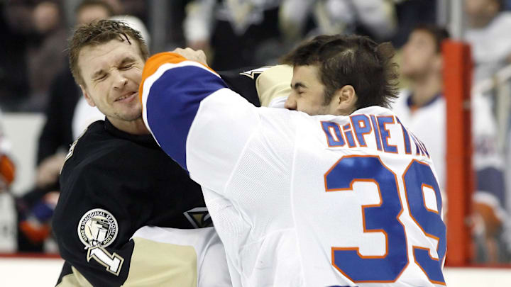 February 2, 2011; Pittsburgh, PA, USA; Pittsburgh Penguins goalie Brent Johnson (left) fights against New York Islanders goalie Rick DiPietro (39) during the third period at the CONSOL Energy Center. The Penguins won 3-0. Mandatory Credit: Charles LeClaire-USPRESSWIRE