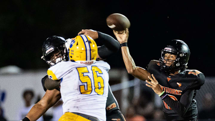 Hawthorne Hornets quarterback Adrian Curtis (12) throws under pressure against the Newberry Panthers during the first half at Hawthorne High School Football Stadium in Hawthorne, FL on Friday, August 30, 2024. [Matt Pendleton/Gainesville Sun]