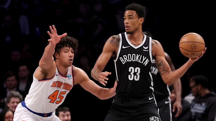 Jan 23, 2024; Brooklyn, New York, USA; Brooklyn Nets center Nic Claxton (33) looks to pass the ball against New York Knicks center Jericho Sims (45) during the first quarter at Barclays Center. Mandatory Credit: Brad Penner-Imagn Images