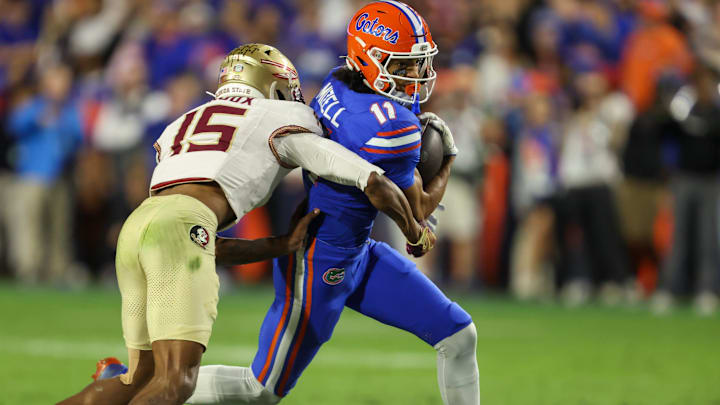 Florida wide receiver Aidan Mizell (11) makes yards against Florida defensive lineman Jayden Woods (15) during the second half of an NCAA football game at Steve Spurrier Field at Ben Hill Griffin Stadium in Gainesville, FL on Saturday, November 29, Florida beat Florida State 40-21.2025. [Alan Youngblood/Gainesville Sun]