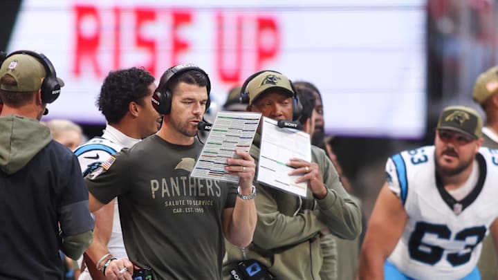 Nov 16, 2025; Atlanta, Georgia, USA; Carolina Panthers head coach Dave Canales studies the playbook in the fourth quarter agianst the Atlanta Falcons at Mercedes-Benz Stadium. Mandatory Credit: Brett Davis-Imagn Images