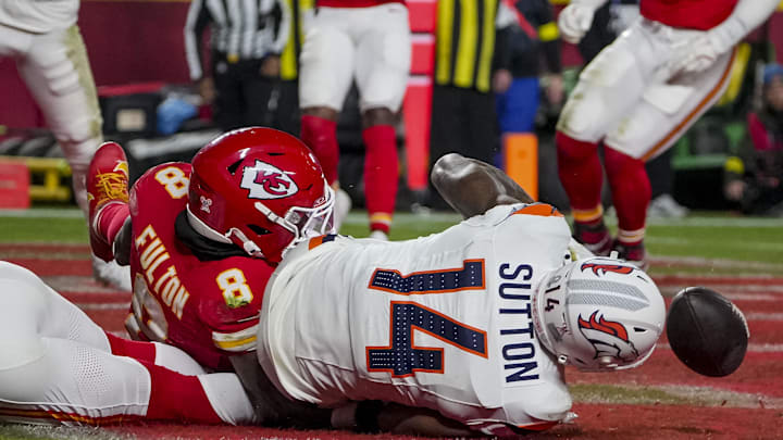 Dec 25, 2025; Kansas City, Missouri, USA; Denver Broncos wide receiver Courtland Sutton (14) can’t hold on to a pass as Kansas City Chiefs cornerback Kristian Fulton (8) makes the tackle in the endzone during the second quarter at GEHA Field at Arrowhead Stadium. Mandatory Credit: Denny Medley-Imagn Images