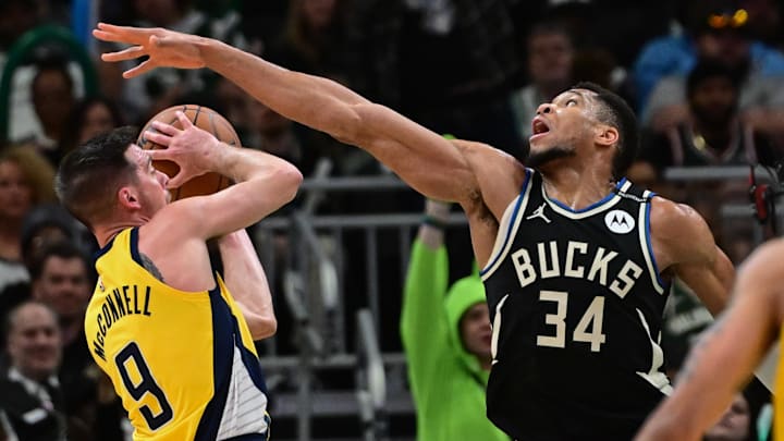 Apr 27, 2025; Milwaukee, Wisconsin, USA; Indiana Pacers guard T.J. McConnell (9) looks for a shot against Milwaukee Bucks forward Giannis Antetokounmpo (34) in the third quarter during game four of first round for the 2024 NBA Playoffs at Fiserv Forum. Mandatory Credit: Benny Sieu-Imagn Images