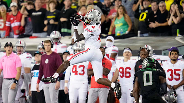 Oct 12, 2024; Eugene, Oregon, USA; Ohio State Buckeyes wide receiver Jeremiah Smith (4) makes a catch against Oregon Ducks defensive back Tysheem Johnson (0) in the second half during the NCAA football game at Autzen Stadium.