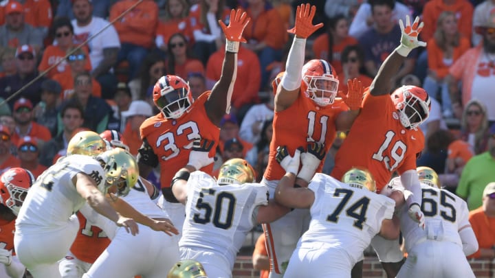 Nov 4, 2023; Clemson, South Carolina, USA; Clemson Tigers defensive tackle Ruke Orhorhoro (33) defensive lineman Peter Woods (11), and defensive lineman DeMonte Capehart (19) play against the Notre Dame Fighting Irish during the third quarter at Memorial Stadium. Nov 4, 2023; Clemson, South Carolina, USA; Clemson Tigers defensive tackle Ruke Orhorhoro (33) defensive lineman Peter Woods (11), and defensive lineman DeMonte Capehart (19) play against the Notre Dame Fighting Irish during the third quarter at Memorial Stadium.