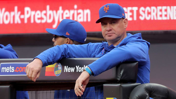 Apr 30, 2026; New York City, New York, USA; New York Mets manager Carlos Mendoza (64) watches from the dugout during the third inning against the Washington Nationals at Citi Field. Mandatory Credit: Brad Penner-Imagn Images