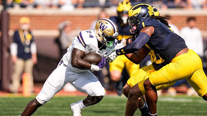 Michigan linebacker Jaishawn Barham (1) tackles Washington running back Adam Mohammed (24) during the first half at Michigan Stadium in Ann Arbor on Saturday, Oct. 18, 2025.