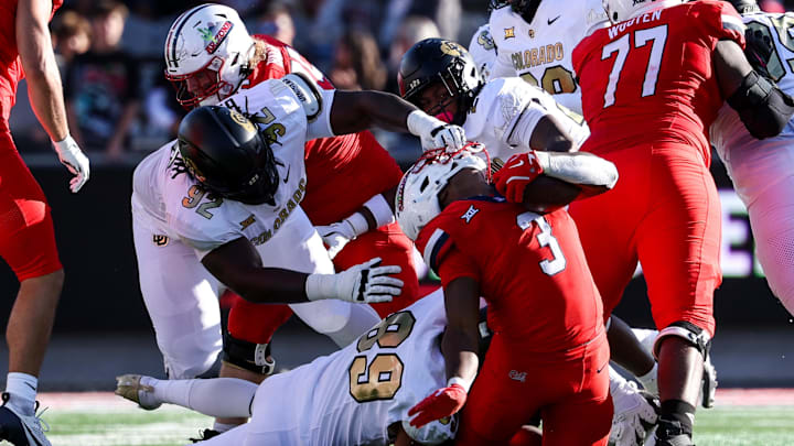 Oct 19, 2024; Tucson, Arizona, USA; Colorado Buffaloes defensive tackle Anquin Barnes Jr. (92) pulls the face mask of Arizona Wildcats running back Kedrick Reescano (3) during the fourth quarter at Arizona Stadium. Mandatory Credit: Aryanna Frank-Imagn Images