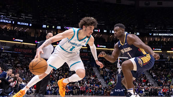 Jan 17, 2024; New Orleans, Louisiana, USA; Charlotte Hornets guard LaMelo Ball (1) loses the ball against New Orleans Pelicans forward Zion Williamson (1) during the second half at Smoothie King Center. Mandatory Credit: Stephen Lew-Imagn Images