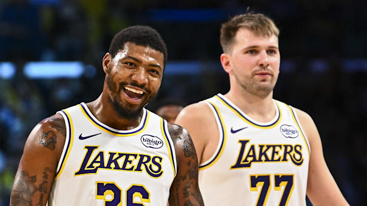 Nov 2, 2025; Los Angeles, California, USA; Los Angeles Lakers guard Marcus Smart (36) reacts with Los Angeles Lakers guard Luka Doncic (77) during a time out against the Miami Heat during the second half at Crypto.com Arena. Mandatory Credit: Jonathan Hui-Imagn Images