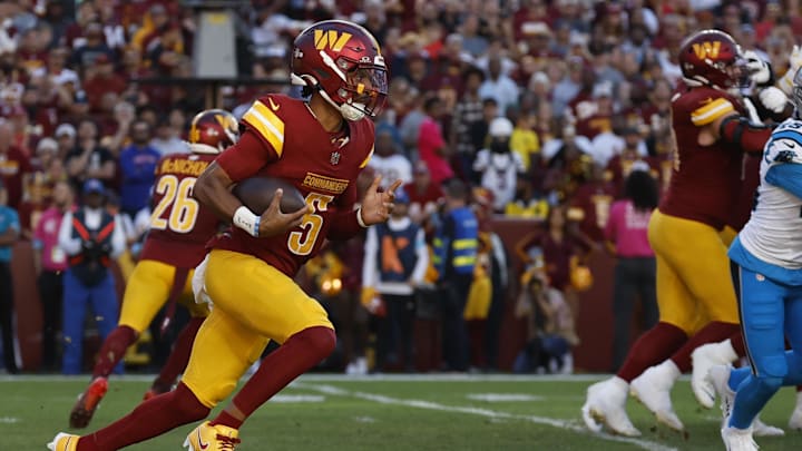Oct 20, 2024; Landover, Maryland, USA; Washington Commanders quarterback Jayden Daniels (5) runs with the ball against the Carolina Panthers during the first quarter at Northwest Stadium. Mandatory Credit: Geoff Burke-Imagn Images